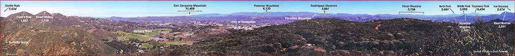 Broad panoramic view of the Del Dios Highlands region showing 14 distant mountain peaks labeled with their elevations listed. Harmony Grove valley is shown before its modern development.