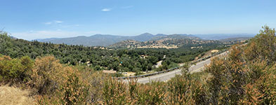 Panoramic view to the south and east from the pulloff along the switchbacks on the South Grade Road showing the valley of the San Luis Rey River in the La Jolla Reservation area with the upland of the Grand Mesa area in the distance to the left.