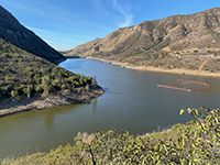 View of the mount of Alva Canyon with the aeration system station barrier on Lake Hodges.