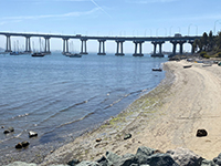View of Coronado Tidewaters Park Beach and west end of San Diego - Coronado Bridge.