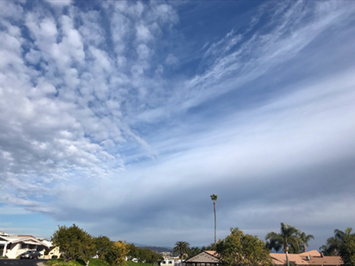 Cumulus, stratus (with virga) and cirrus clouds