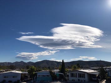 Altocumulus lenticularis (lenticular orographic clouds) rise over the coast mouthans south of Double Peak in San Marcos, CA