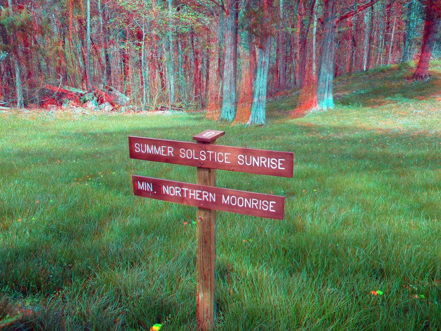 Arrow on sign indicating the direction of the summersolstice sunrixe and minimum northern moonrise.