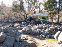 Destruction caused by a post-fire debris flow in Cable Canyon, California, 2004.