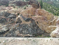 A wall of rocks exposed in a cliff illustrate the verticle view illustrated by cross section. This cliff is in Wind River Canyon, Wyoming.