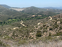 View looking down the Green Valley Truck Trail with Warren Canyon and Lake Poway Dam in the distance.
