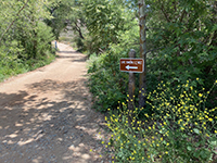 Sign along Green Valley Truck trail saying 1.2 miles to Lake Ramona.