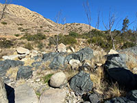 Large basalt and granite boulders on the river floodplain.