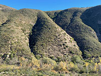 Another view of the high mountainside on the south side of Del Dios Gorge showing two ravines draining into the river bed.