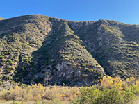 Yet another view of the high mountainside on the south side of Del Dios Gorge showing two ravines draining into the river bed.