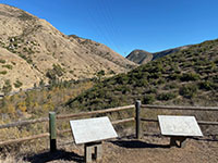 View of Del Dios Gorge with a overlook fence and weathered displays.
