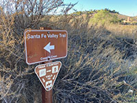 A small brown trailhead sign for the Santa Fe Valley Trail.