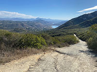 View looking down the Del Dios trail with Lake Hodges in the valley about a mile off in the distance.