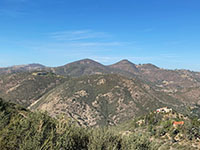 View across the San Elijo Gorge to the chaparral covered mountainsides and highlands adjaceted to several mountain peaks including Double Peak, Franks Peak, and Mt. Whitney, left to right.