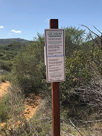 A trail sign marking the boundary between the Los Cielos Preserve and the Elfin Forest Recreational Reserve.