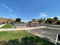 Butterfield Elementary with fault scarp of a strand of the Chino Fault behind building and north end of the parking lot.