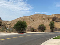 View of Chino Hills near Chino Fault trace across the street from Butterfield Elementary Echool with an oil well on the hillside.