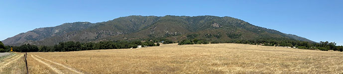 This panoramic view is from a pulloff on southbound CA 79 at the pass between Rincon and the turnoff to the South Grade Road to Palomar Mountain (shown here) The Elsinore Fault runs across the mountain front, basically following a series of scarps, sidehill benches. The fault trace basically follows the boundary shown as change in vegetation (lower is chaparral and upper is mostly pine forest).