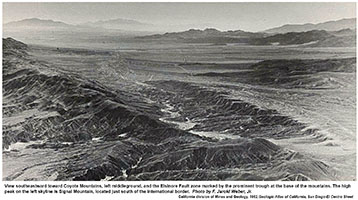 Pre-1964 black-and-white aerial veiw looking south along the Coyote Mountains. The Elsinore Fault follows roughly along the base of the mountain front. Mountains in Mexico south of the Laguna Salada area are in the distance.
