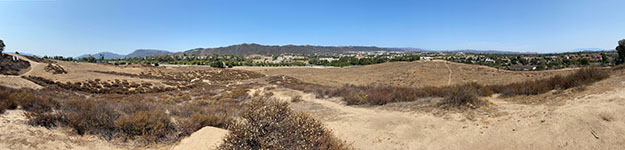 Panoramic view looking south-west-north (left to right) from a hilltop overlooking the Wildomar Fault zone from a hilltop overlooking fields next to Temecula Duck Pond Park. Stream drainages appear to be deflected along fault zone that runs parallel to Ynez Drive to the southeast of the Duck Pond area.