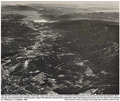An aerial photograph taken from an airplane before 1964 looking northeast along the Elsinore Trough from above Murietta with lake Elsinore in the distance.
