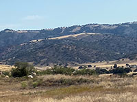 View looking west across the Santa Ysabel Creek  valley to the mountainsides in the Santa Ysabel East Preserve with the higher Volcan Mountains ridgeline beyond the Elsinore Fault canyon.
