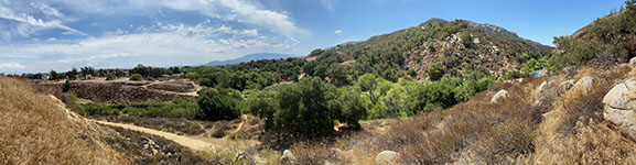 Panoramic view looking east to south from the top of a side-hill bench on the north side of the mouth of Temecula Canyon. The Willard Fault cuts across the canyon and then runs the mountain front near the break in slope south of the canyon.