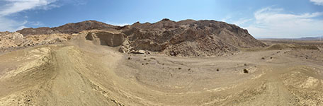 Panoramic view of the young fault scarp of the Coyote Mountains section of the Elsinore Fault Zone near the mouth of Fossil Canyon. Nearly flat-lying Plio-Pleistocene sedimentary deposts are faulted adjacent to Mesozoic-age igneous and metamorphic rocks. 