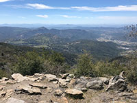 View from Palomar Mountain State Park of the Elsinore Fault Valley with town of Rincon to right. Switchback on South Grade Road are on the slope in foreground.