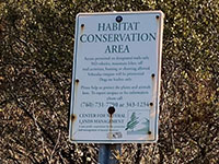 A small sign showing the Center For Natural Lands Managements rules for trail access.