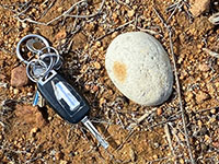 Example or a rounded stream or beach cobble. Car keys for scale.