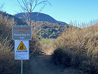 Fire damage sign along Mid Valley Mesa Trail.