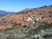 White granitic boulders and outcrops stand out on the red-soil hillside along the upper trail in the Gap area.