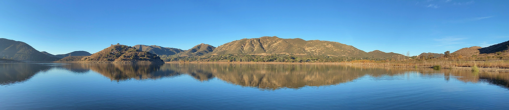 Panorama of Lake Hodges from the Fishing Dock showing a nice reflection of the mountainous landscape on the lake.