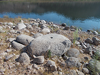 Prehistoric mortar on a flat-top granite boulder on the south shore of Lake Hodges.
