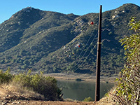 Powerline pole and lines crossing Lake Hodges.