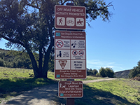 This sign with trails and park rules is posted near the trailhead parking area off of Pamo Road.