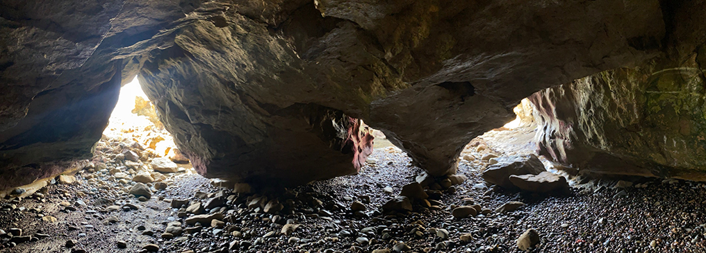 Panoramic view from inside a small sea cave in the cliffs along La Jolla Bay showing three separate entrances to an underground chamber. This is a +180 degree view.