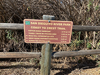 Sign at the intersection of the Coast To Crest Trail near the parking area for the Old Coach Trail.