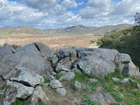Granite boulders and outcrop with a view of San Pasqual Valley in the distance.