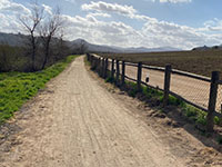 Wetlands to south (left of the Mule Hill Trail, agricultural field to north (right).
