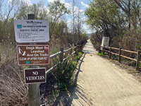 Signs and a stream gage  for the San Dieguito River along Mule Hill Trail.