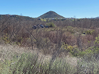 Battle Mountain and wetlands with a granite boulder outcrop pile south of the trail.