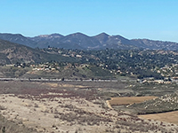 Zoom view with distant peaks: Double Peak, Franks Peak and Mount Whitney, Felicita Mesa  in mid view. Mule Hill Trail in foreground to the right.