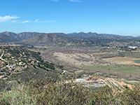 View looking west toward the higher peaks of the Coastal Highlands region with the peaks of Bernardo mountain, Double Peak, Franks Peak, and Mt. Whitney near San Marcos.