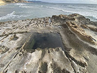 This square water-filled pit was an exploratory shaft constructed in an unsuccessful attempt to find a coal bed layer in the Delmar Formation.