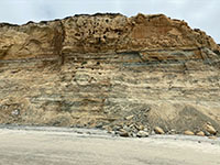 Rockfall material accumulating at the base of the seacliff at Torrey Pines Beach