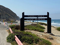 Sign to the entrance to the Torrey Pine State Nature Reserve along Torrey Pines Road near the park entrance.