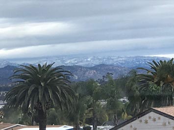 Zoomed in view of altostratus clouds between San Marcos and the high snow-covered peaks near Julian, CA