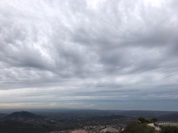 Altocumulus clouds grading into altostratus and nimbostratus clouds over the ocean as seen from Double Peak in San Marcos, CA